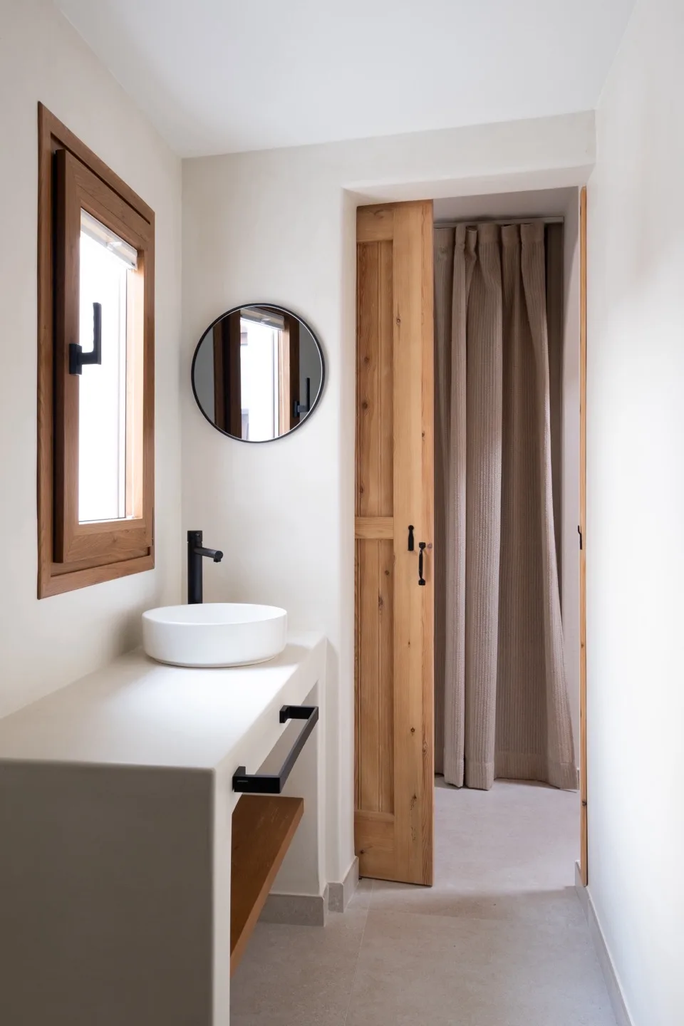 Paraíso — bathroom with blue glazed tile shower and black hardware
