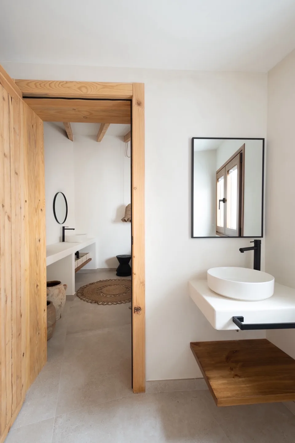 Paraíso — bathroom with pine barn door, vessel sink, and connected rooms