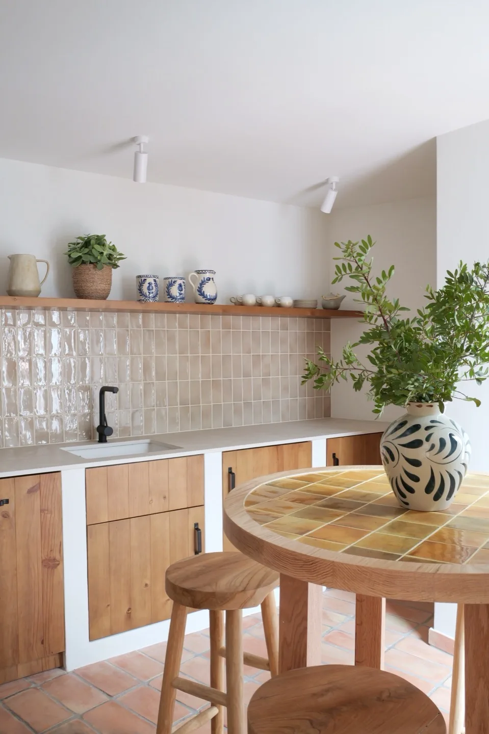 Paraíso — kitchen detail with pine cabinets, cutting boards, and open shelving